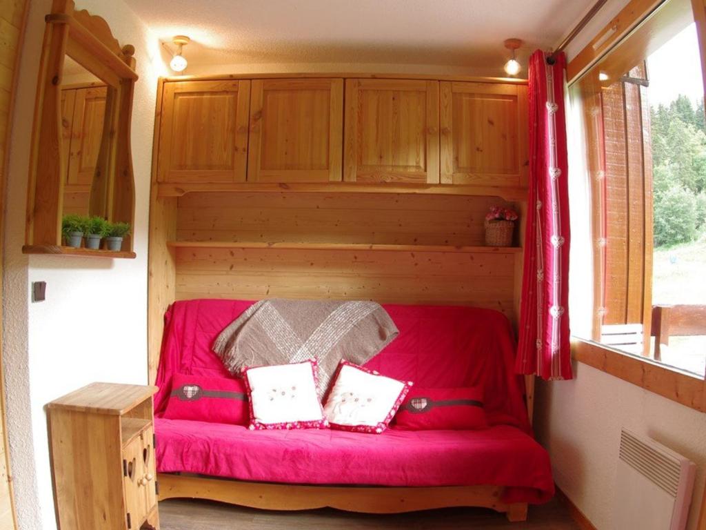 un canapé rouge à l'arrière d'une petite maison dans l'établissement Appartement Valmorel, 2 pièces, 5 personnes - FR-1-291-756, à Valmorel