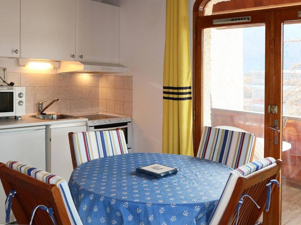 a kitchen with a table with a cell phone on it at Studio Les Orres, 1 pièce, 4 personnes - FR-1-322-194 in Les Orres