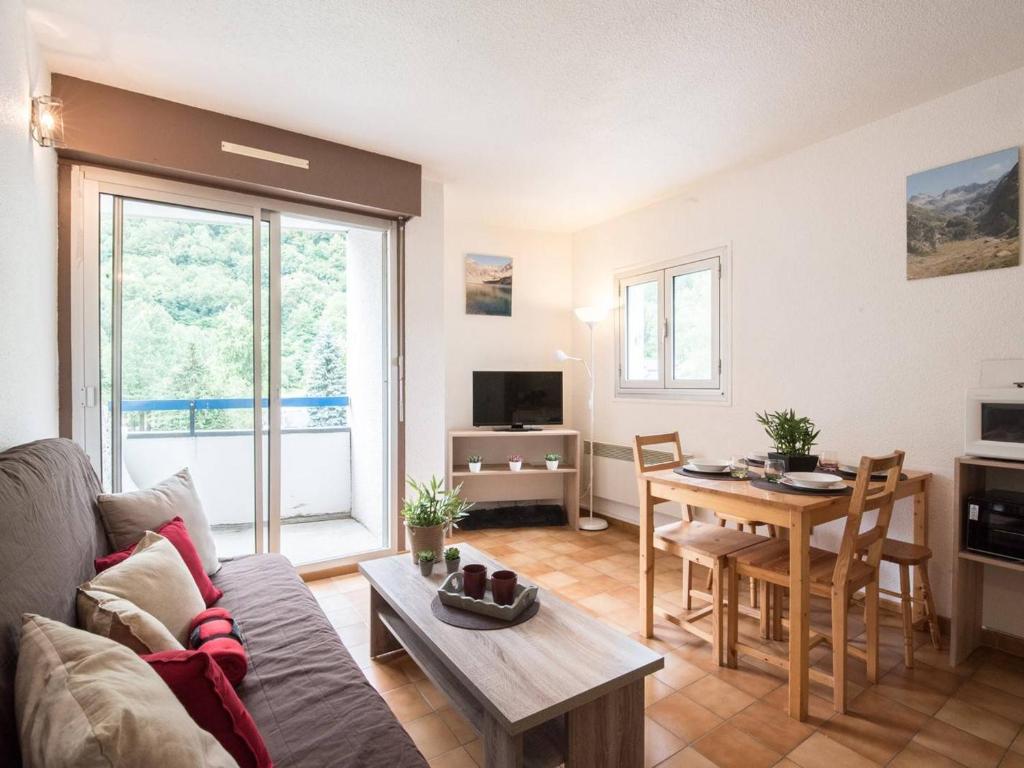 a living room with a couch and a table at Studio Saint-Lary-Soulan, 1 pièce, 4 personnes - FR-1-296-163 in Saint-Lary-Soulan