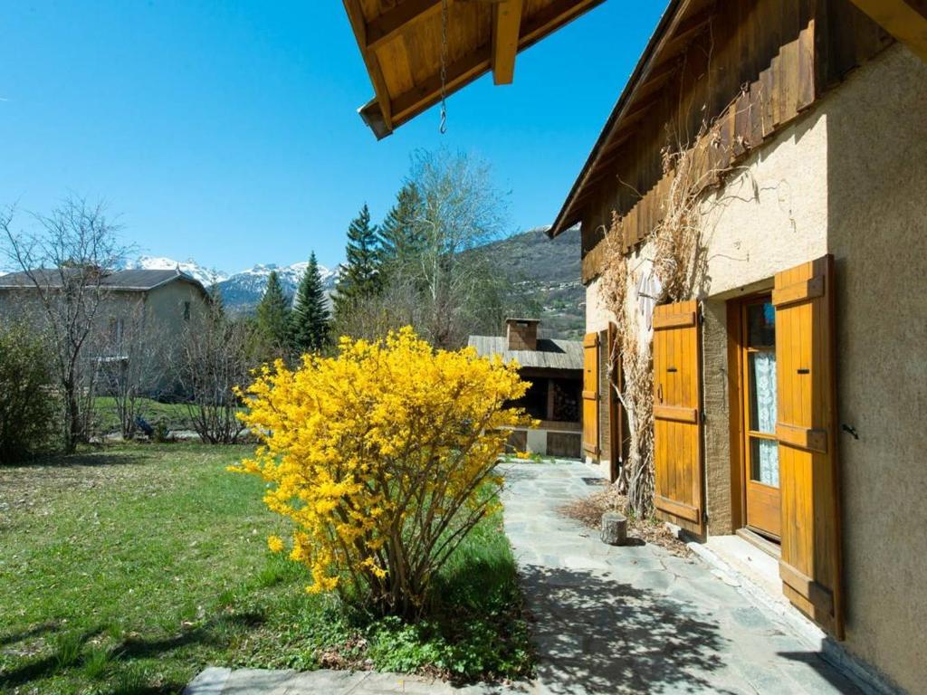 a yellow bush in front of a building at Maison Briançon, 6 pièces, 14 personnes - FR-1-330C-71 in Briançon