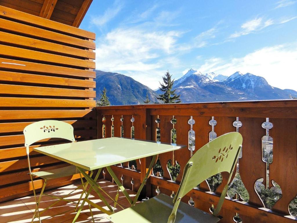 d'une table et de chaises sur un balcon avec vue sur les montagnes. dans l'établissement Bel appartement 67m² 2 chambres, parking, balcon sud – Briançon - FR-1-330C-72, à Briançon