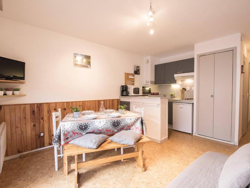 a kitchen with a table with a table cloth on it at Appartement Saint-Lary-Soulan, 2 pièces, 4 personnes - FR-1-296-224 in Saint-Lary-Soulan