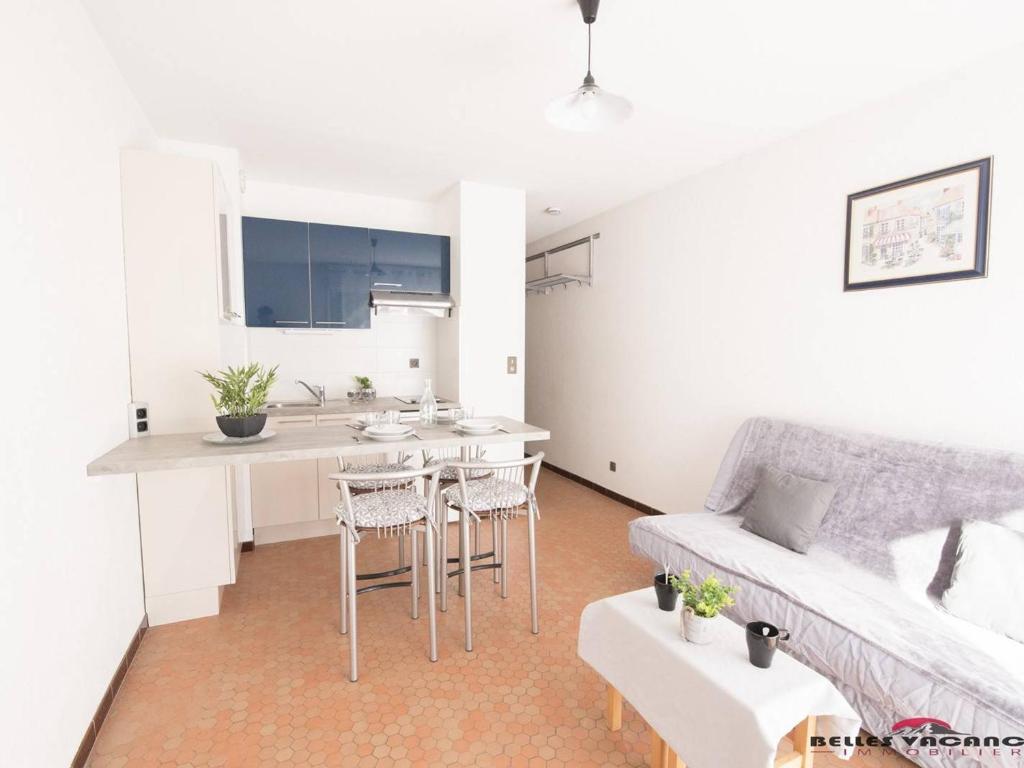 a living room with a couch and a kitchen at Appartement 4 personnes à Saint Lary village - FR-1-296-231 in Saint-Lary-Soulan