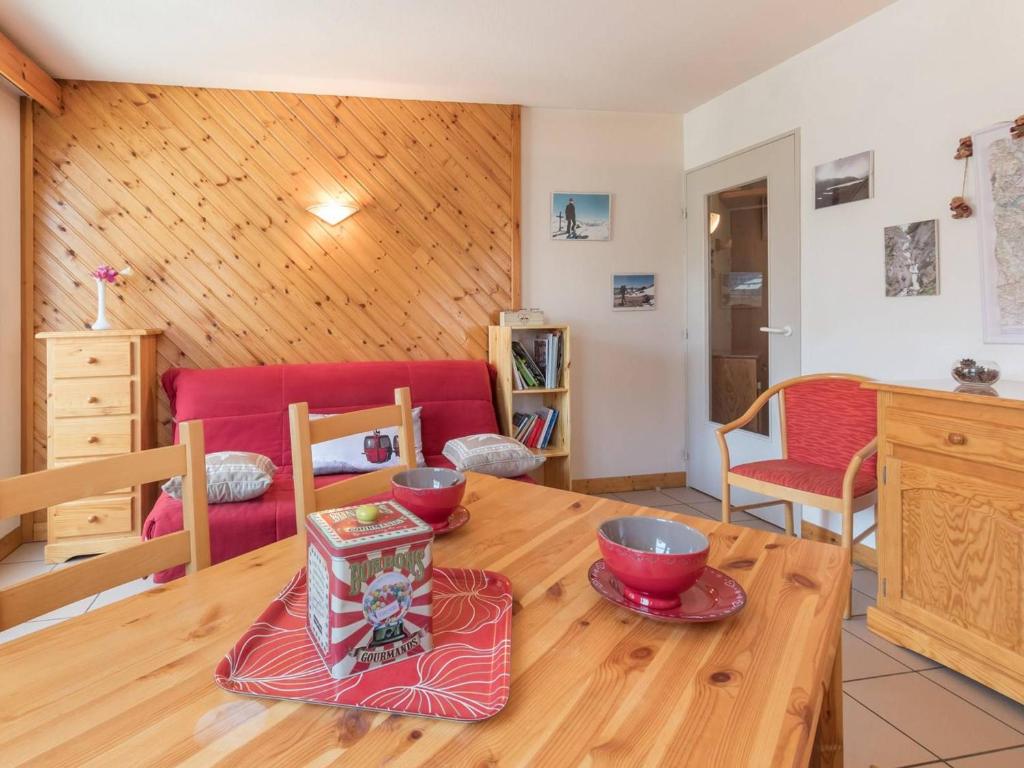 una sala de estar con una mesa de madera con cuencos. en Appartement Briançon, 2 pièces, 4 personnes - FR-1-330C-19 en Briançon