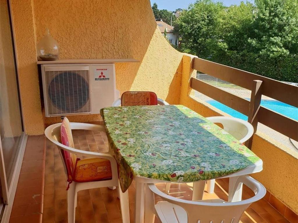 a table and chairs on a balcony with a heater at Appartement Argelès-sur-Mer, 3 pièces, 4 personnes - FR-1-388-128 in Argelès-sur-Mer