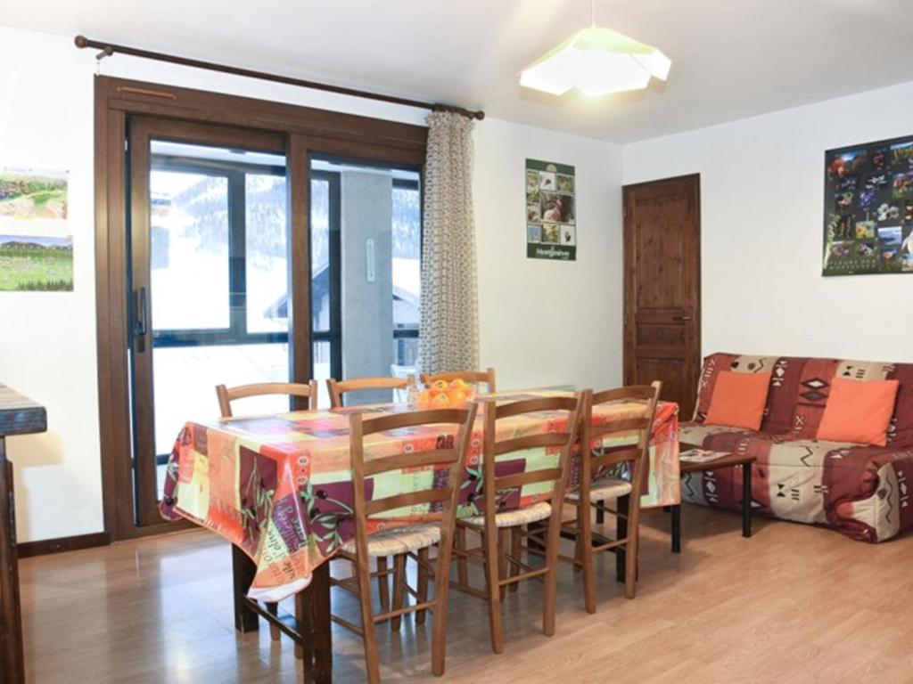 une salle à manger avec une table et des chaises dans l'établissement Appartement cosy 6/7 pers, au centre de Montgenèvre, exposé sud, loggia et casier à skis. - FR-1-266-109, à Montgenèvre