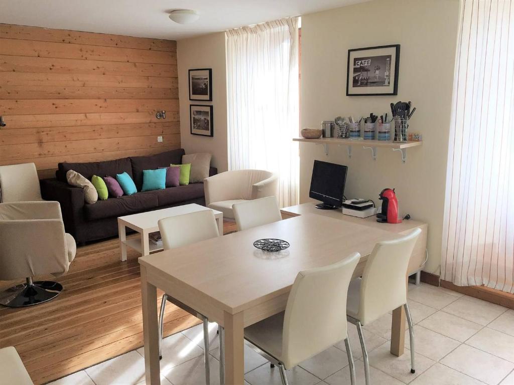 a living room with a table and chairs and a couch at Appartement Briançon, 3 pièces, 8 personnes - FR-1-330C-84 in Briançon