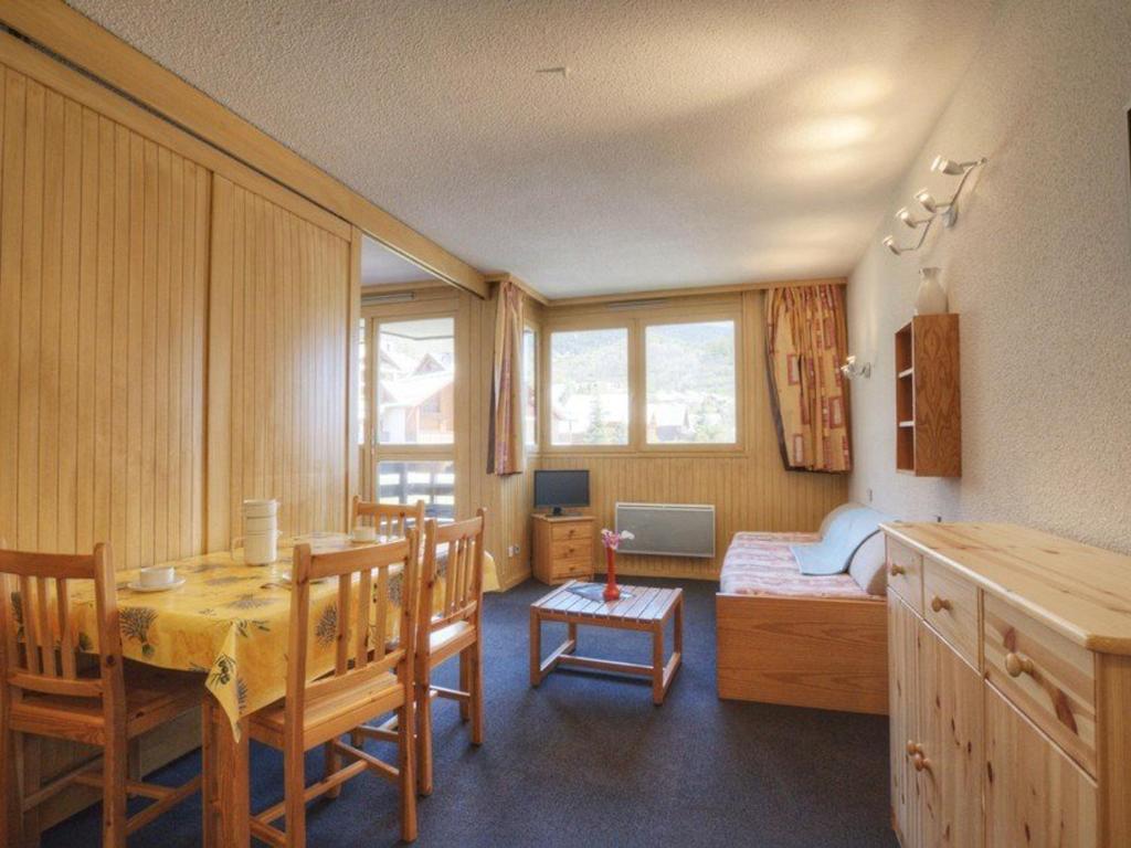 - une chambre avec une table et un lit dans l'établissement Séjour montagne à Serre-Chevalier, appartement 4 pers. avec balcon, proche commerces. - FR-1-330E-69, à Saint-Chaffrey