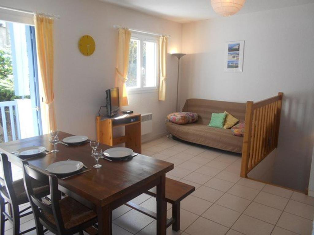 a living room with a table and a couch at Appartement Cauterets, 3 pièces, 4 personnes - FR-1-401-50 in Cauterets