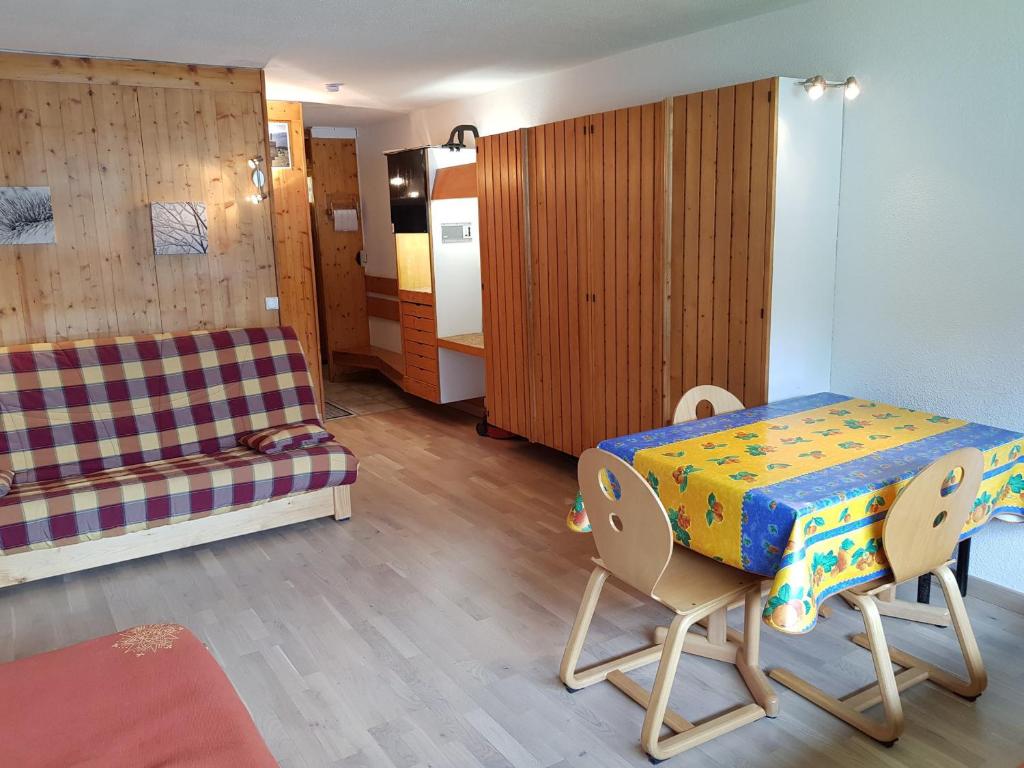 a room with a table and chairs and a couch at Studio Les Arcs 1600, 1 pièce, 3 personnes - FR-1-411-413 in Arc 1600