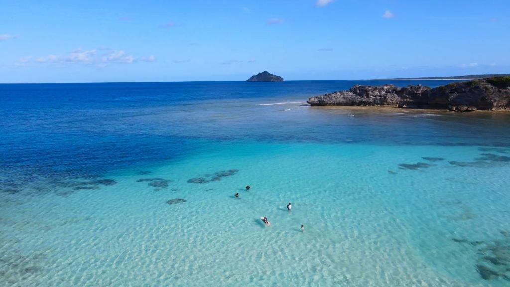 a group of people swimming in the ocean at Loedi Bungalows Rote in Nembrala