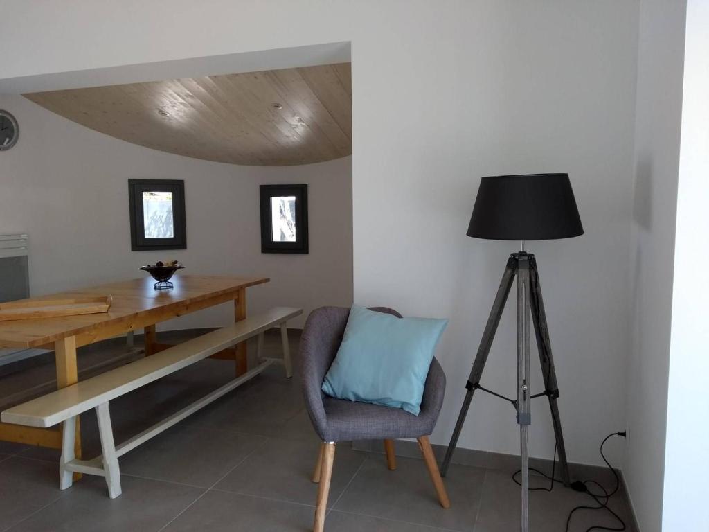 a room with a table and a chair and a lamp at Maison Noirmoutier-en-l&#39;Île, 4 pièces, 6 personnes - FR-1-224B-646 in Noirmoutier-en-l&#39;lle