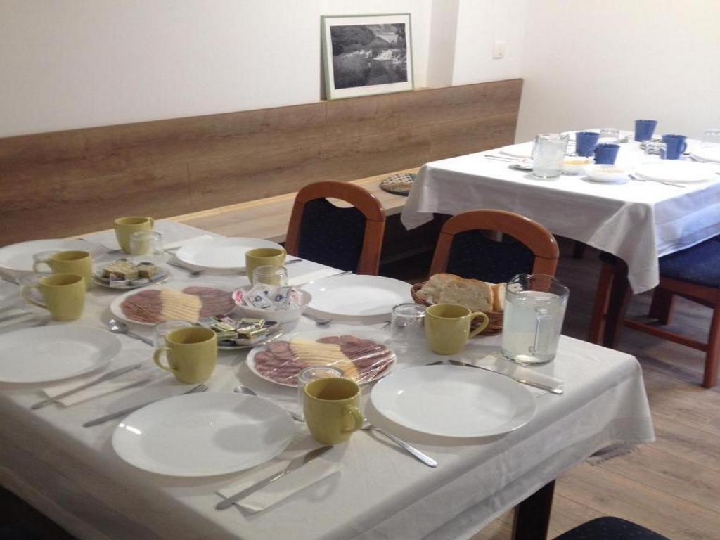 a table with plates of food on it at Guesthouse Family Bosnic in Plitvička Jezera