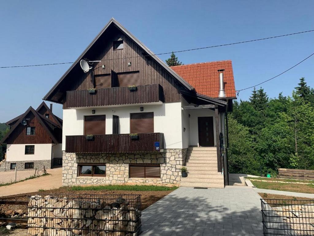 a house with a brown and white at Guesthouse Family Bosnic in Plitvička Jezera