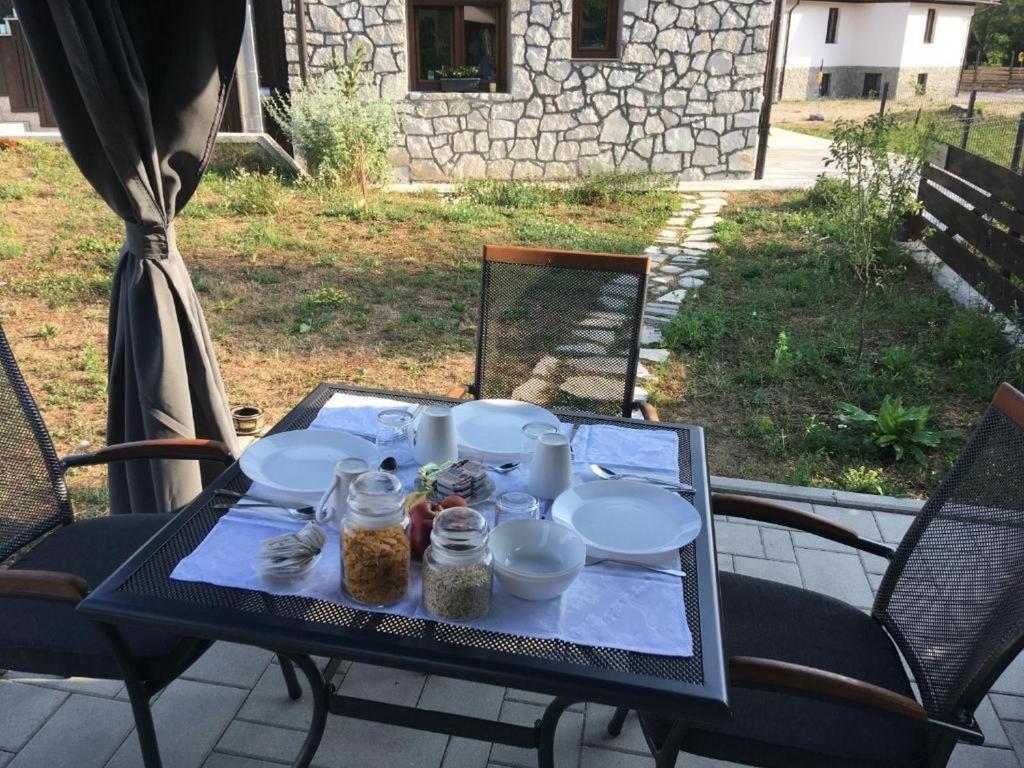 a table with plates and jars on top of it at Guesthouse Family Bosnic in Plitvička Jezera