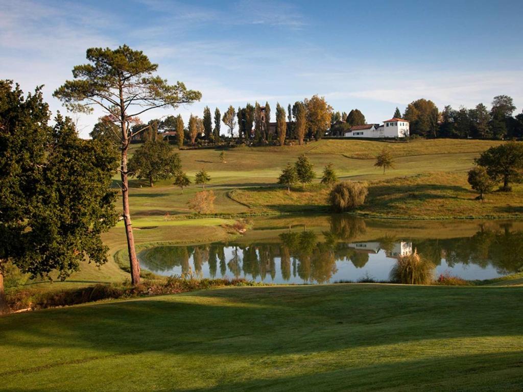 a view of a golf course with a pond at Appartement Arcangues, 3 pièces, 4 personnes - FR-1-3-475 in Arcangues