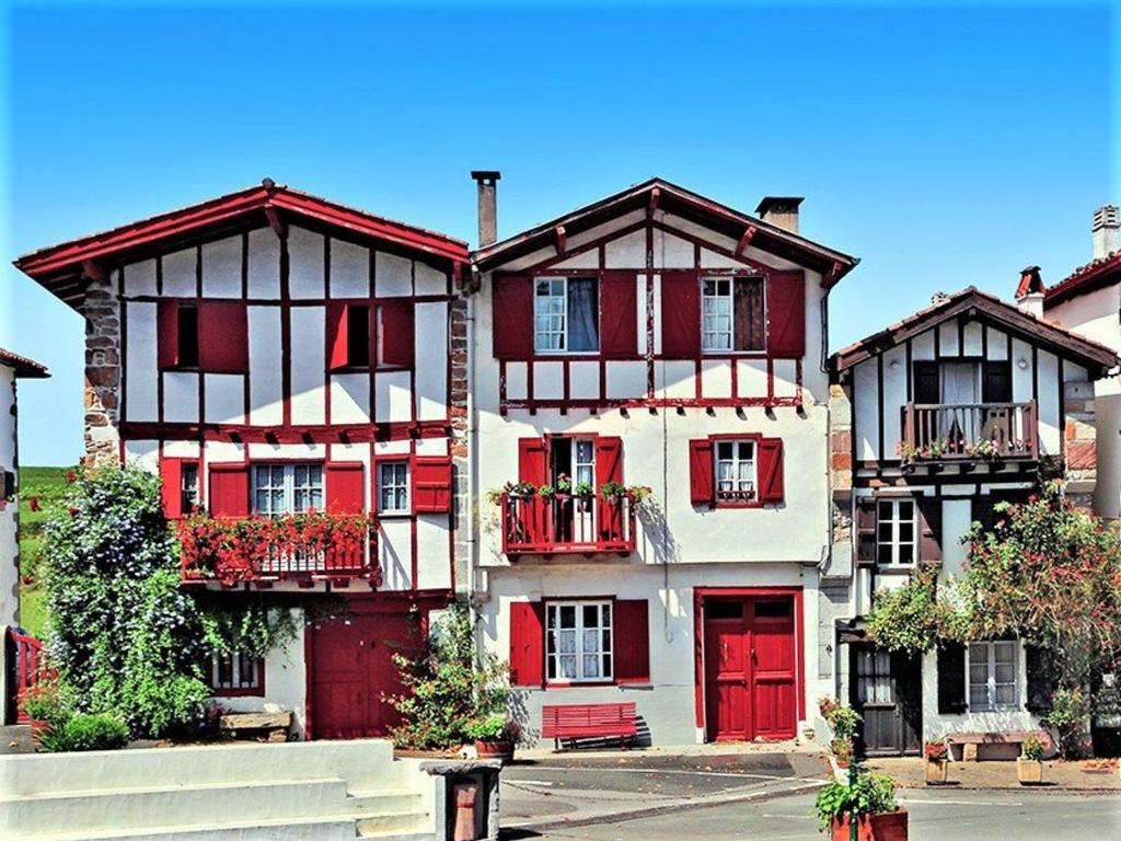 a large building with red doors and windows at Appartement Arcangues, 3 pièces, 4 personnes - FR-1-3-475 in Arcangues