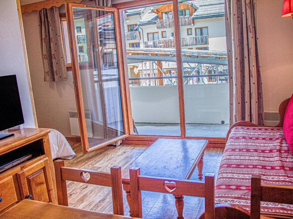 ein Wohnzimmer mit einem Sofa und einem großen Fenster in der Unterkunft Appartement Les Orres, 2 pièces, 6 personnes - FR-1-322-330 in Les Orres