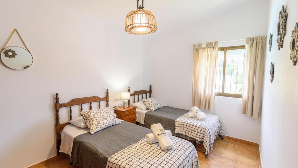 A bed or beds in a room at Casa rural cerca de Aracena Castillo de las Guardas by Ruralidays