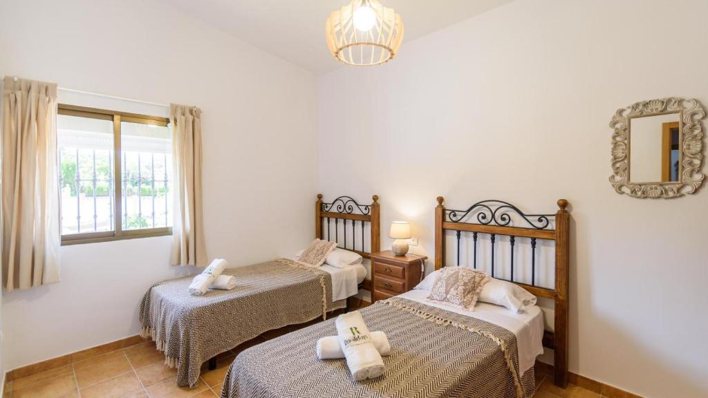 A bed or beds in a room at Casa rural cerca de Aracena Castillo de las Guardas by Ruralidays