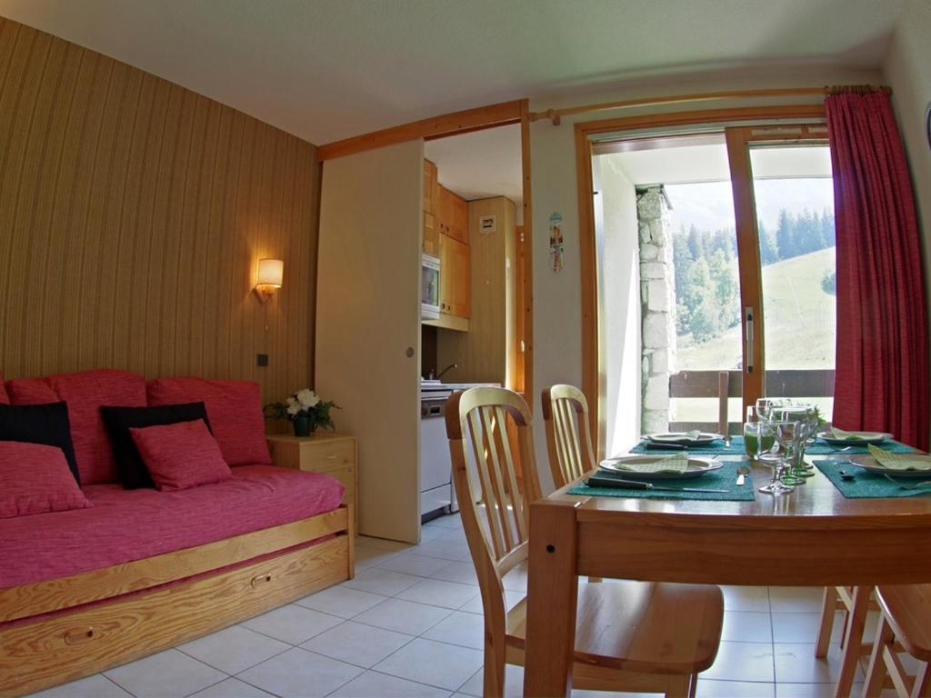 a living room with a dining room table and a couch at Appartement Valmorel, 2 pièces, 5 personnes - FR-1-291-822 in Valmorel