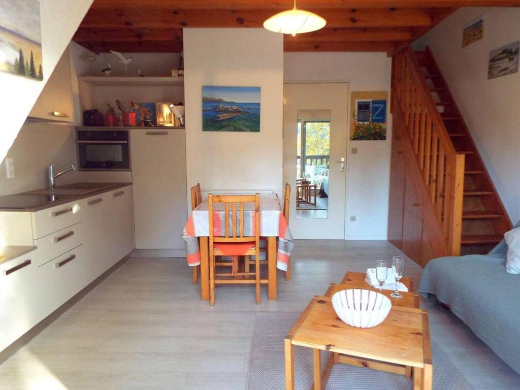 a kitchen and a living room with a table and chairs at Appartement Carnac, 3 pièces, 5 personnes - FR-1-477-51 in Carnac
