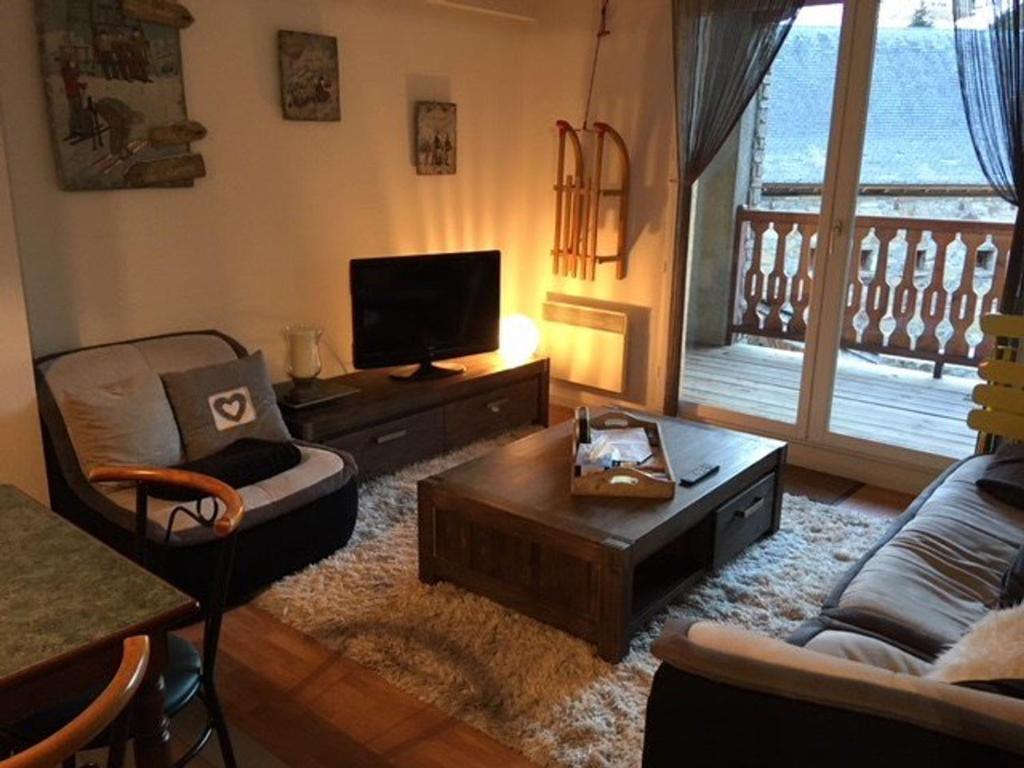 a living room with a couch and a tv at Appartement La Mongie, 3 pièces, 4 personnes - FR-1-404-200 in La Mongie