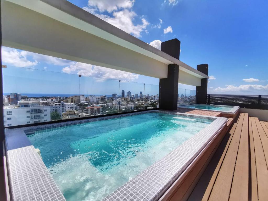 a swimming pool on the roof of a building at 1br Luxury Condo Jacuzzigym Mountains with parking lot in Los Prados