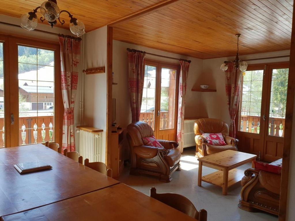 a living room with a wooden table and chairs at Chalet Arêches-Beaufort, 6 pièces, 12 personnes - FR-1-342-198 in Arêches-Beaufort