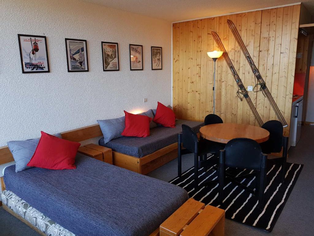 a hotel room with two beds and a table at Studio pour 4 à Arc 1600 proche des pistes et commerces - FR-1-411-625 in Arc 1600