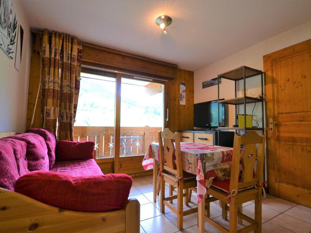 a living room with a couch and a table at Appartement Flumet, 2 pièces, 4 personnes - FR-1-505-69 in Flumet