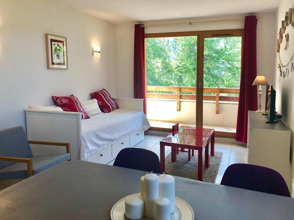 a living room with a bed and a table at Appartement Les Orres, 2 pièces, 4 personnes - FR-1-322-370 in Les Orres
