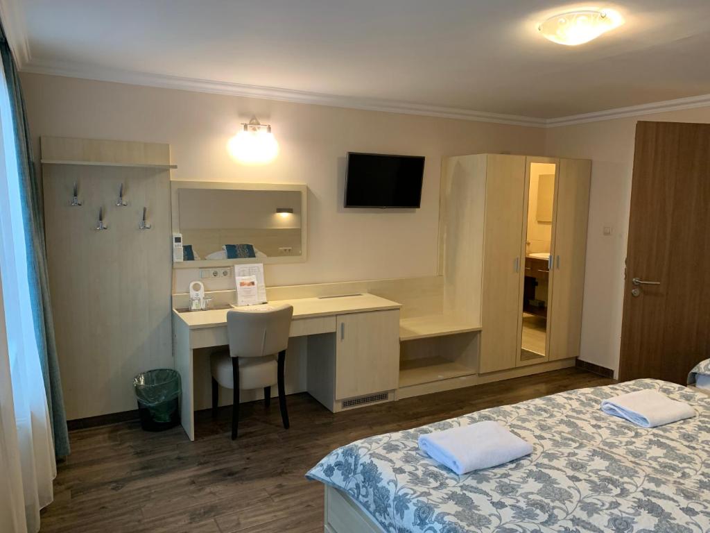 Posteľ alebo postele v izbe v ubytovaní Nimród Hotel és Ètterem