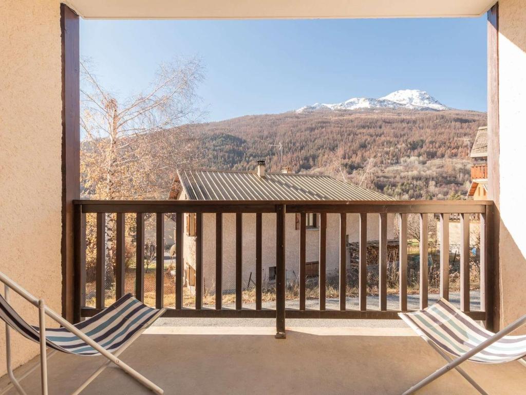 d'un balcon avec deux chaises et une vue sur la montagne. dans l'établissement Appartement 2 pièces avec parking à Briançon - FR-1-330C-98, à Briançon