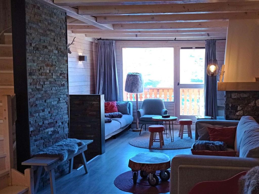 a living room with a couch and a fireplace at Chalet Val Thorens, 6 pièces, 11 personnes - FR-1-545-27 in Val Thorens