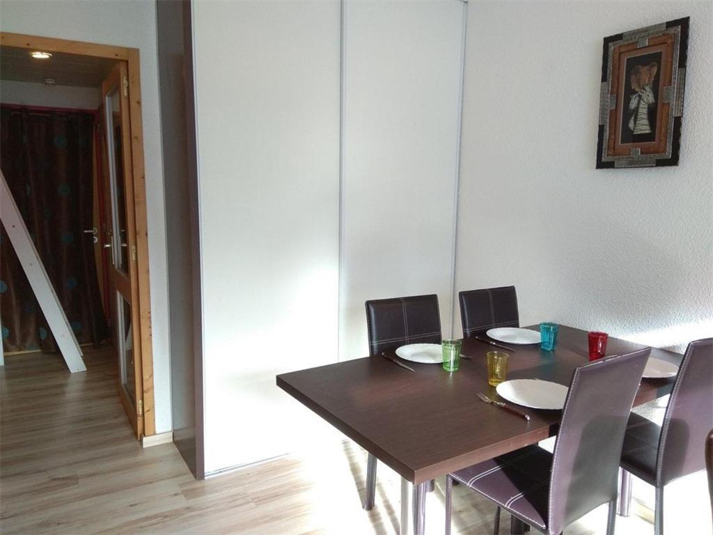 a dining room with a wooden table and chairs at Studio Piau-Engaly, 1 pièce, 4 personnes - FR-1-457-226 in Aragnouet