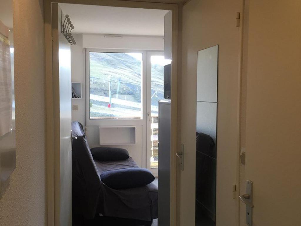 un salon avec une chaise et une fenêtre dans l'établissement Studio 4 pers. au pied des pistes avec balcon, ascenseur, parking gratuit, casier à skis et équipement complet - FR-1-602-3, à Arette