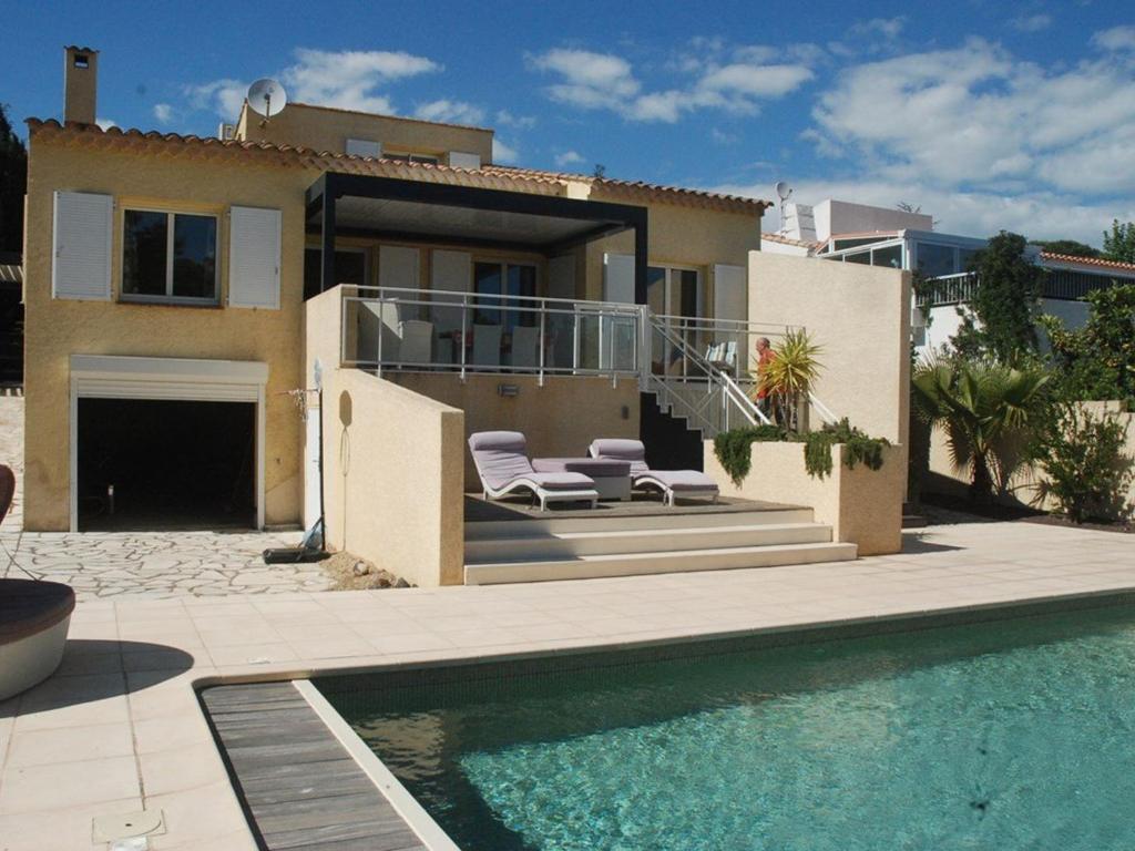 a house with a swimming pool in front of a house at Villa climatisée avec piscine privée pour 6 personnes proche plage et port, calme et confortable - FR-1-607-26 in Cap d'Agde