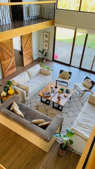 a living room with a couch and a table at Casa Familiar Puerto Varas in La Ensenada