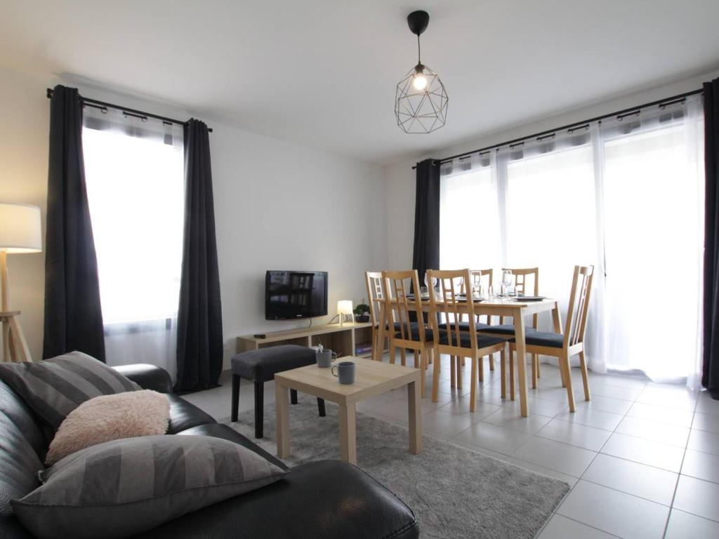 a living room with a couch and a table and chairs at Appartement lumineux 4P/8 pers, 2 terrasses, parking privé, cœur de Briançon - FR-1-330C-119 in Briançon