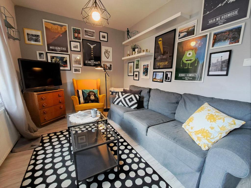 a living room with a blue couch and a tv at Gryfny Grubiorz in Katowice