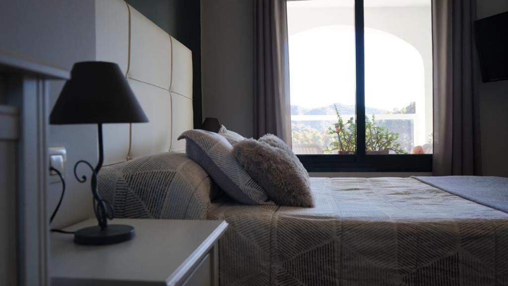 A bed or beds in a room at Mirador De La Axarquia