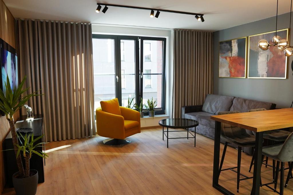 a living room with a couch and a table at HALO Apartament 07 in Wrocław