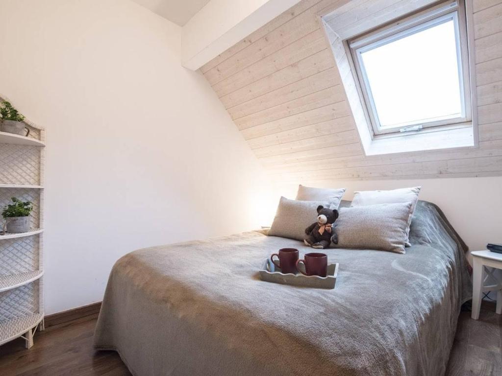 a bedroom with a bed with a teddy bear on it at Appartement Saint-Lary-Soulan, 4 pièces, 10 personnes - FR-1-296-340 in Saint-Lary-Soulan