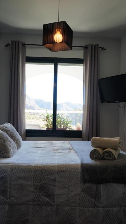 A bed or beds in a room at Mirador De La Axarquia