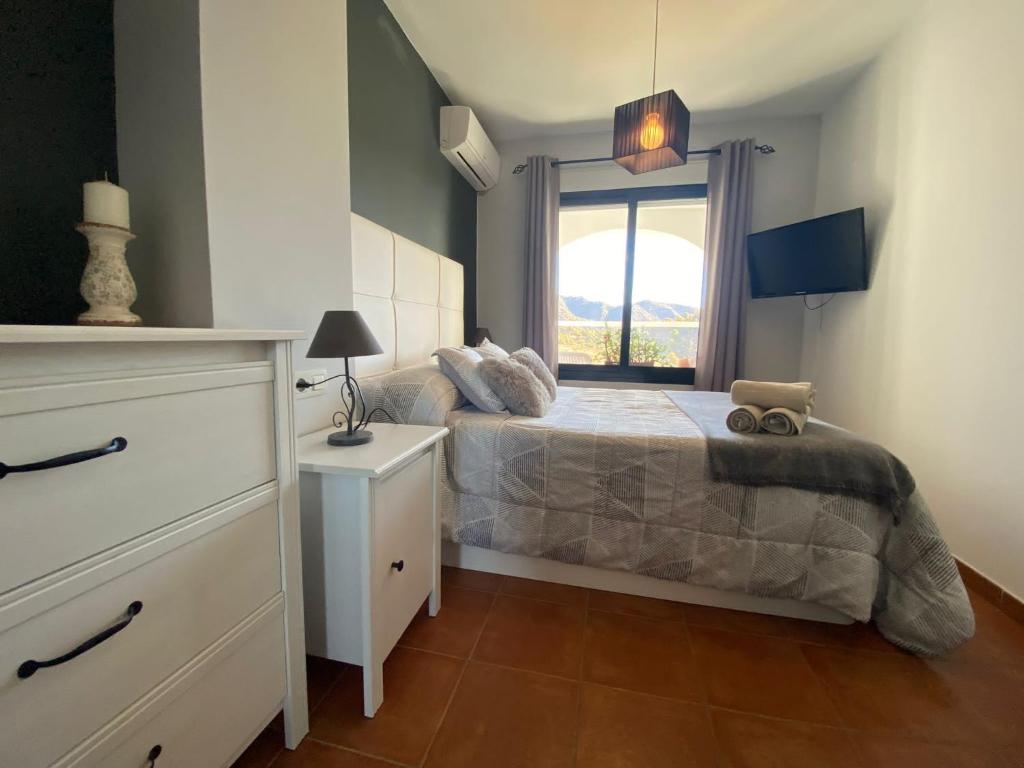 A bed or beds in a room at Mirador De La Axarquia