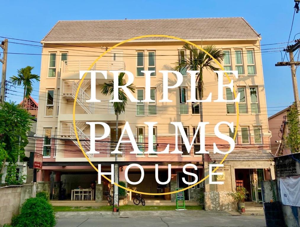 a building with a sign that reads happy palms house at Triple Palms House in Chiang Mai