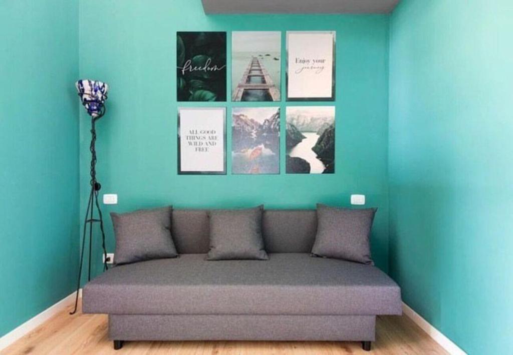 a room with a bed with pictures on the wall at Milan Emerald Home ''Wifi & Self Check-in'' in Milan