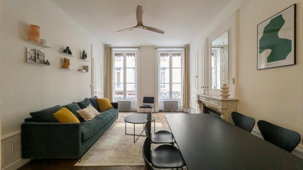a living room with a couch and a table at NOCNOC - Le Rayonnant in Lyon