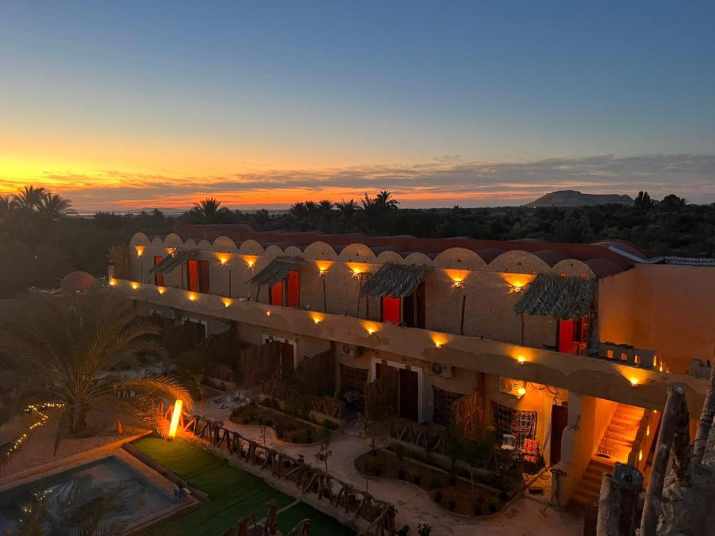 an aerial view of a hotel at sunset at Aghurmi Siwa Ecolodge & Salt Cave in Siwa